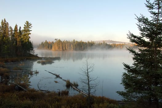 A beautiful autumn's landscape in the morning with fog and mist