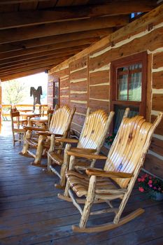 3 rocking-chair on the front porch of a traditional old farm