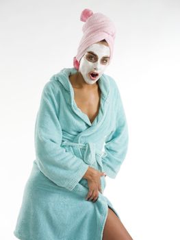 cute and nice girl with face cream mask posing and making face