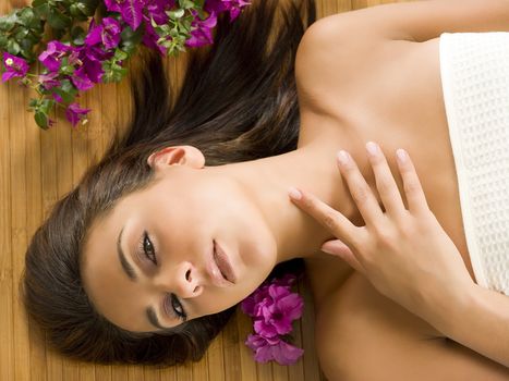 portrait of a beautiful brunette laying down on a wood carpet