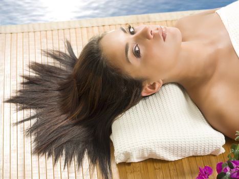 portrait of a beautiful brunette laying down on a wood carpet