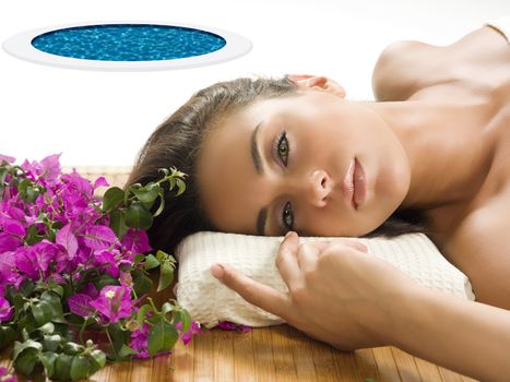 very cute brunette with wonderful eyes laying down on a wood carpet in a beauty farm