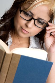 Beautiful young woman reading book