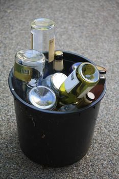 A bucket filled with empty bottles