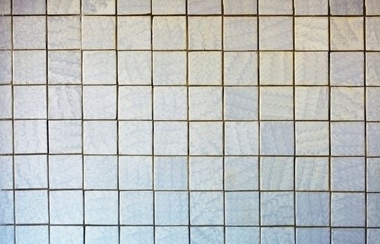 Wall covered with an old grey tile - a background