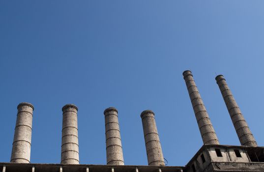 Six old abandoned factory chimneis in Italy