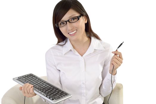 Beautiful Asian business woman smile and hold computer keyboard on white background.