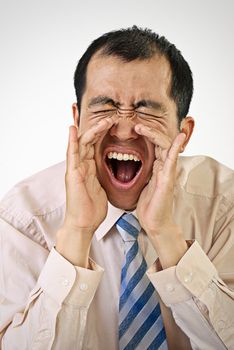 Yelling business man portrait with mouth open on white background.