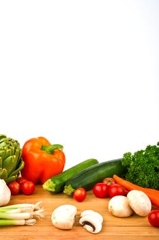 Image of a variety of colorful vegetables on a cutting board with a knife