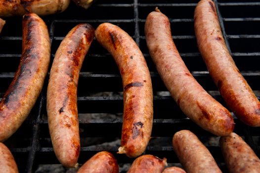 Image of sausages cooking on a grill