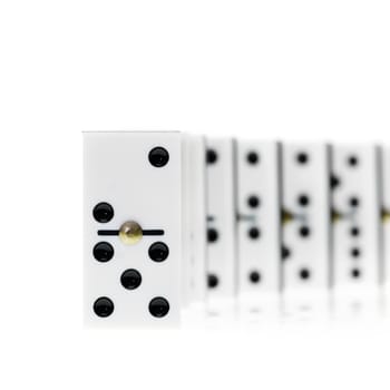 Chain of white domino stones on white background, focus on first