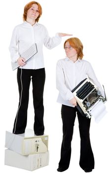 Two girls. One with the computer keyboard, and the second with a typewriter