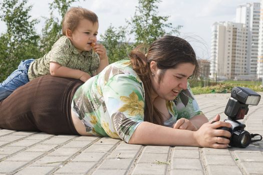 Woman with a photo camera and her son