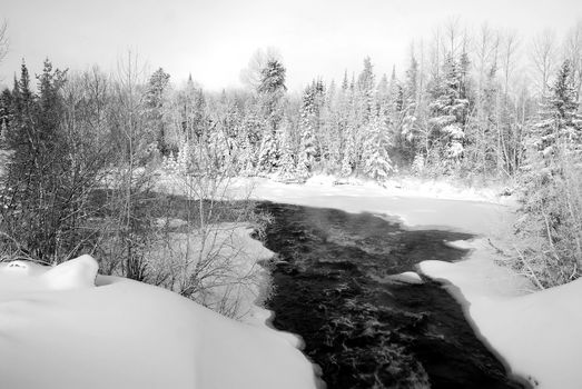 A landscape showing a frozen river in Winter