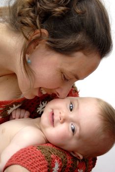 Portrait of mother sweetly holding her baby