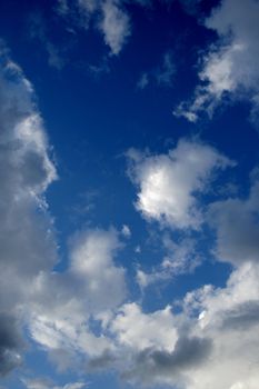 Dark blue sky with white clouds