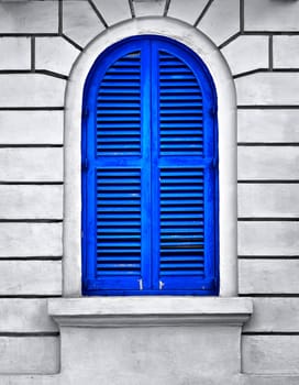 A blue louvered window