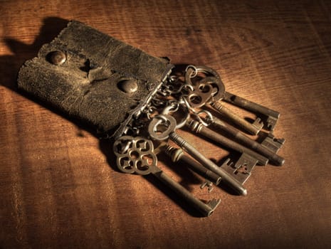 An old leather keyring over a wooden table.