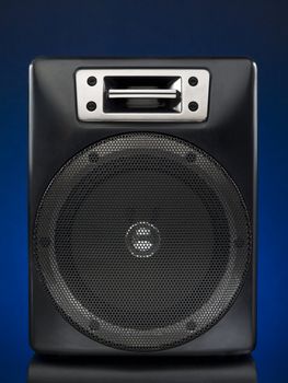 A black speaker over a blue background.