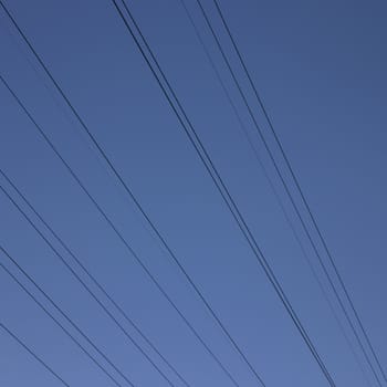 black electric wires in the blue sky