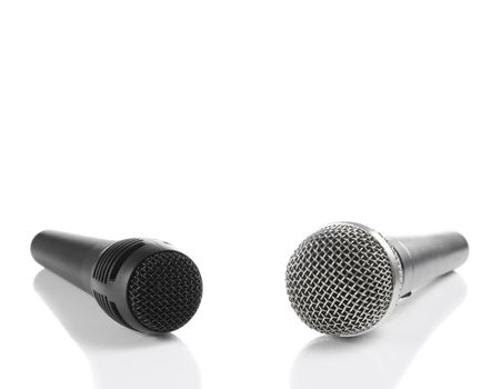 A black and a silver microphones isolated with copyspace.