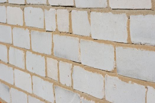 Texture of a wall of the house from a white brick. A background