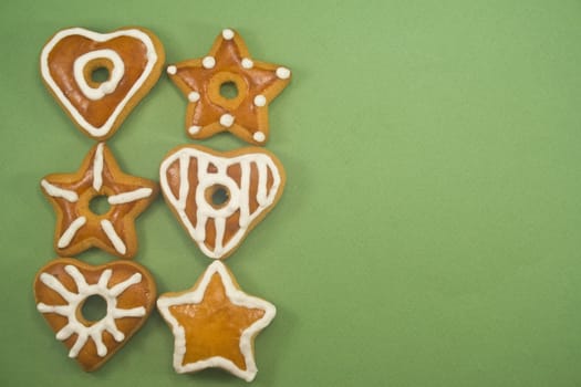 Gingerbread cookies in two lines against green background with ad space on right