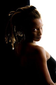 African American woman with dreadlocks against black and white wall