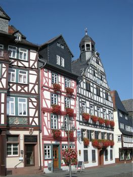 Historic building facades of Butzbach, Germany, with flowering window boxes, timber framing.