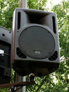 Outdoor public loudspeakers i on green background