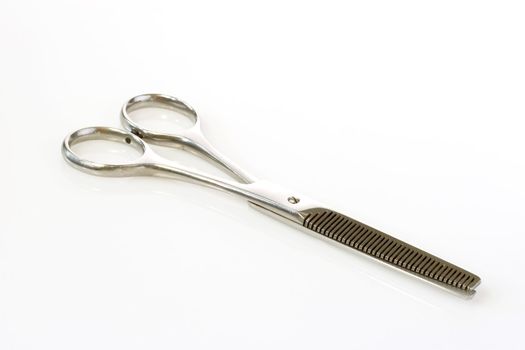 Haircutting scissor on bright background