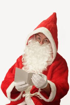 Male caucasian model of santa claus holding a sheet of paper - isolated on white background
