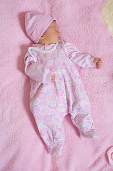 children series: slepping newborn baby in pink color