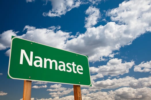 Namaste Green Road Sign with Copy Room Over The Dramatic Clouds and Sky.