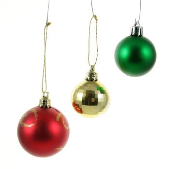 A three isolated hanging Christmas baubles.
