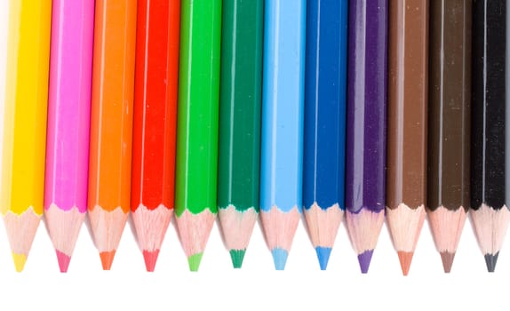 close-up many colour pencils in a row, isolated on white