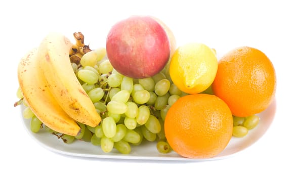 close-up many fruits on plate, isolated on white