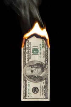 Image of a one hundred dollar bill on fire