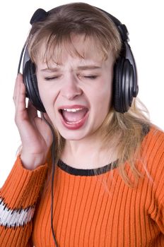 Young smiling singing woman is listening to the music with closed eyes over white