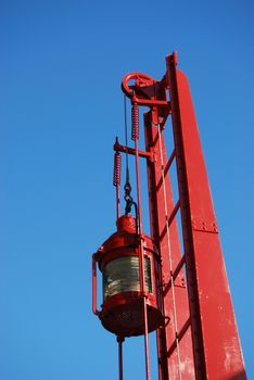 red lantern of a lighthouse against the blue sky