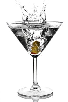 Olive splashing on martini isolated on white stock photo