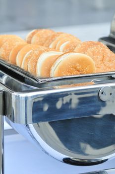 sesame buns for burgers served in a catering dish