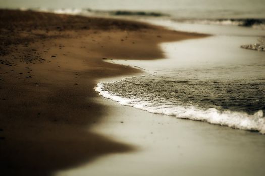 Picture of a wave landing on a sandy beach