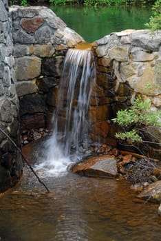 Picture of a natural small water fall in summer