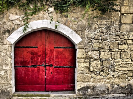 Red medieval door rich in texture