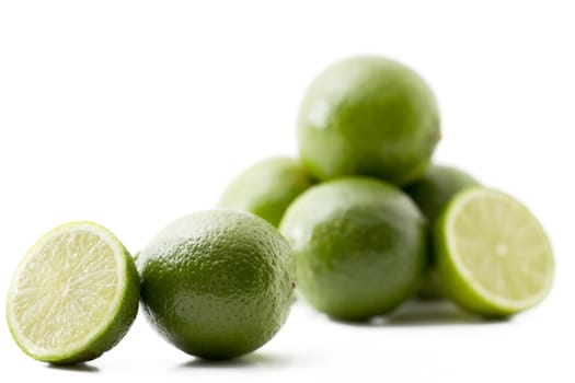 one lime and a half in front of others on white background