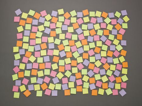 Adhesive Notes with different colors on grey background