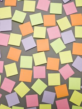 Adhesive Notes with different colors on grey background