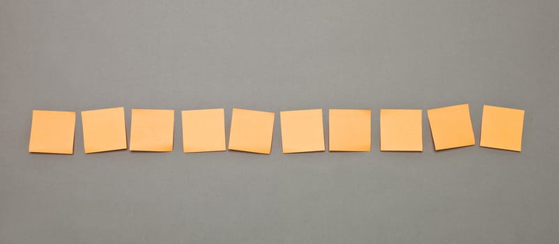 Orange Adhesive Notes in a row
