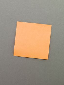 Orange Adhesive Note on grey background